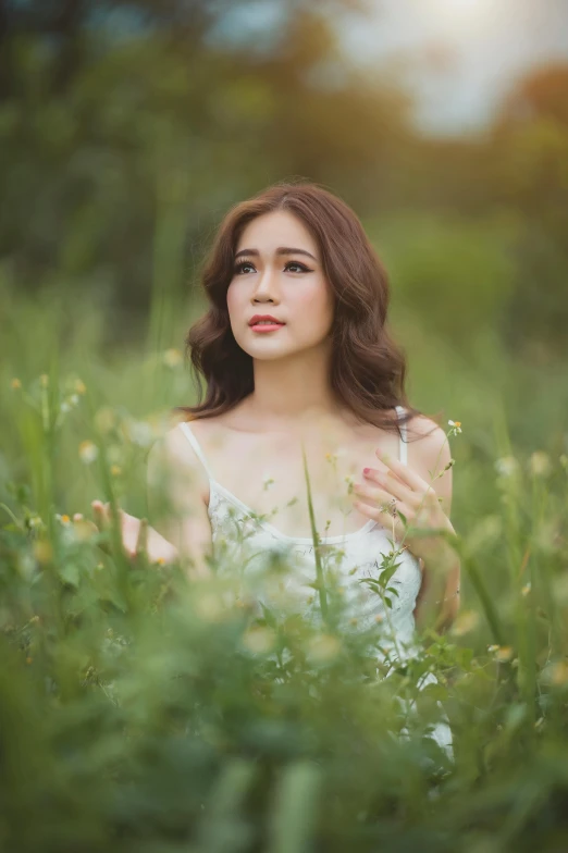 a woman standing in a field of tall grass, a picture, inspired by Kim Du-ryang, 5 0 0 px models, square, vietnamese woman, low quality photo