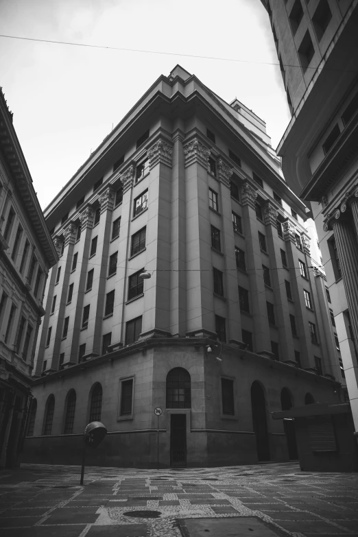 a black and white photo of a building, by Altichiero, unsplash contest winner, neoclassicism, são paulo, grainy low quality, square lines, old buildings