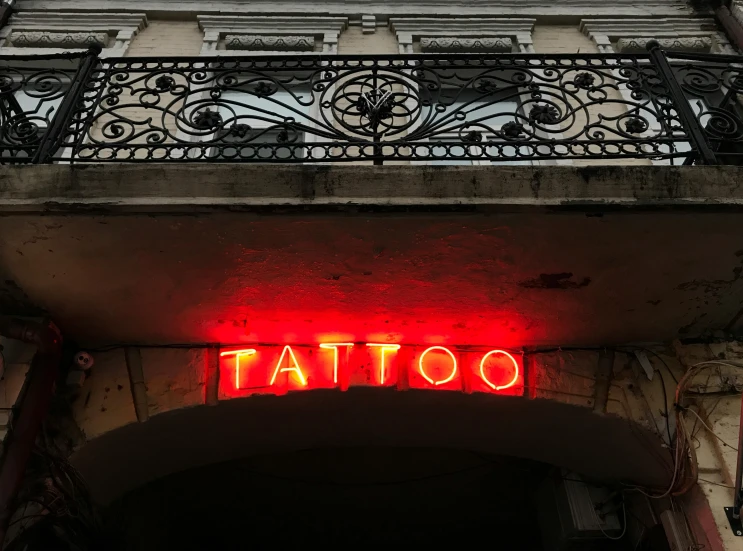 a building with a sign that says tattoo, a tattoo, by Emma Andijewska, pexels contest winner, high red lights, decoration, 2 0 0 0's photo, fan favorite