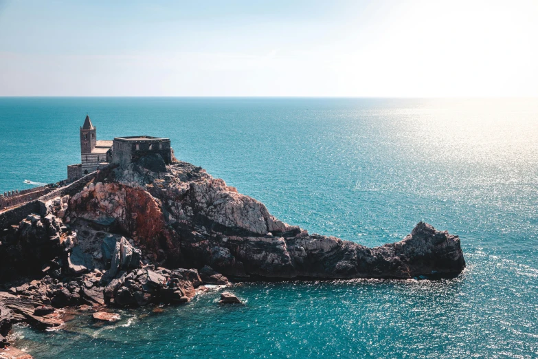 a lighthouse sitting on top of a cliff next to the ocean, turquoise water, count of monte cristo, set photo, high quality product image”