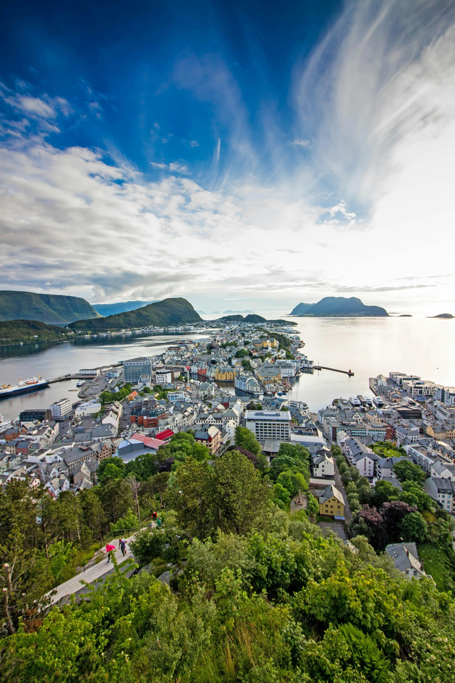 a large body of water next to a lush green hillside, inspired by Johan Christian Dahl, art nouveau, mountains and a huge old city, harbour, photograph from above, square