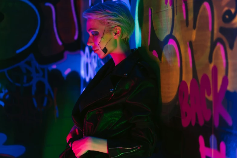 a woman standing in front of a graffiti covered wall, cyberpunk art, inspired by Elsa Bleda, trending on pexels, girl with short white hair, cyberpunk with neon lighting, very aesthetic leather jacket, nightlife