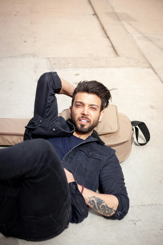 a man laying on the ground next to a skateboard, by Adam Dario Keel, renaissance, a handsome man，black short hair, diego fazio, color photo, square masculine jaw