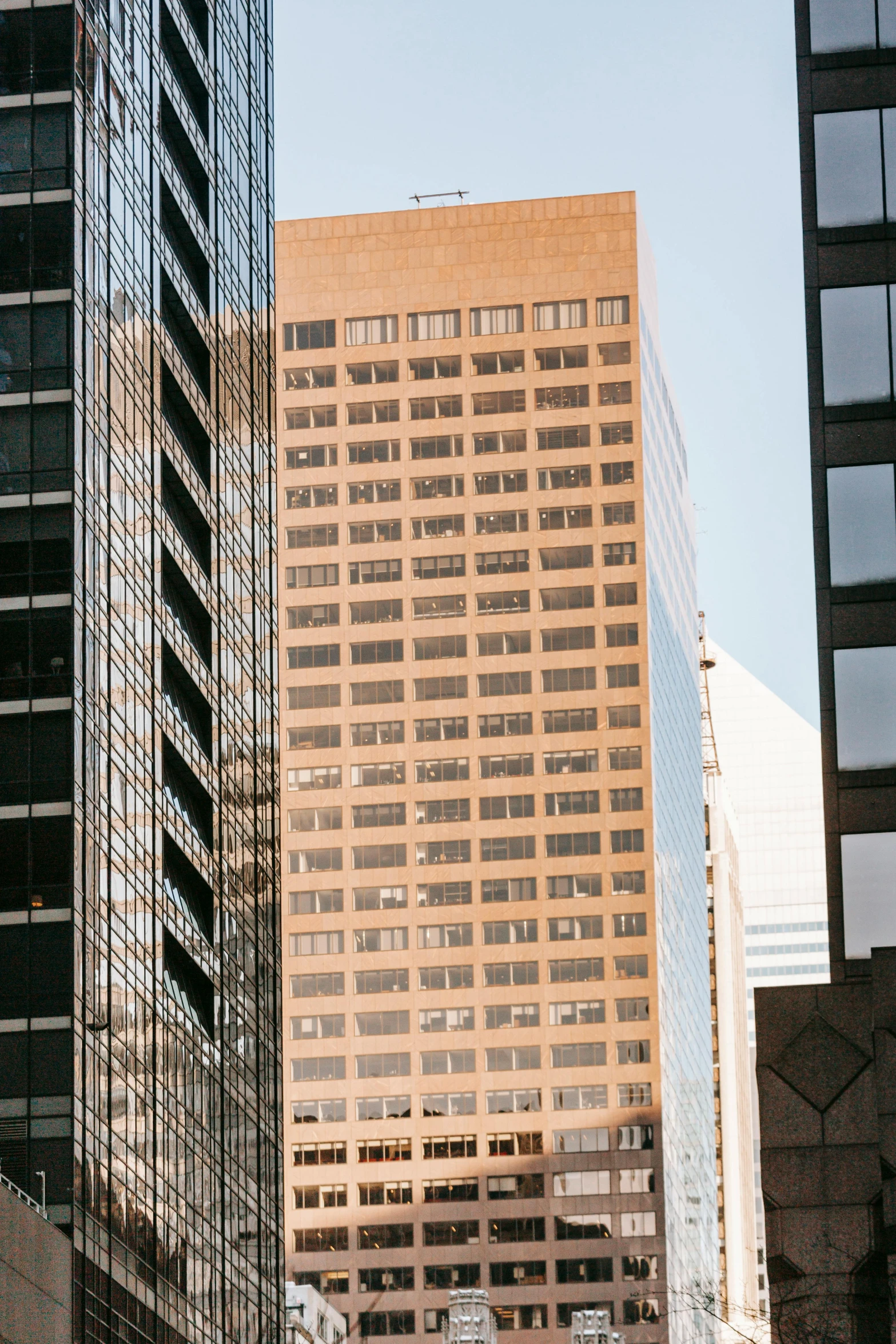 a city street filled with lots of tall buildings, inspired by Thomas Struth, trending on unsplash, golden windows, brown, exterior view, minneapolis