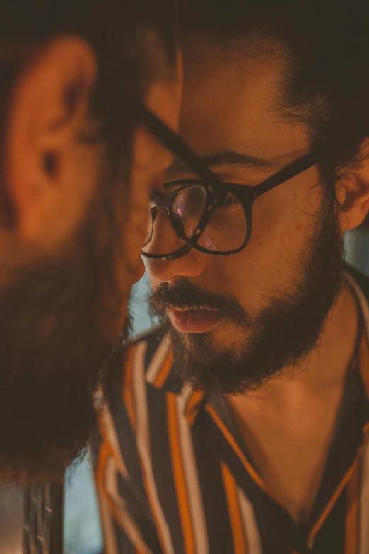 a man sitting in front of a laptop computer, pexels contest winner, romanticism, facing each other, with glasses and goatee, bisexual lighting, looking in the mirror