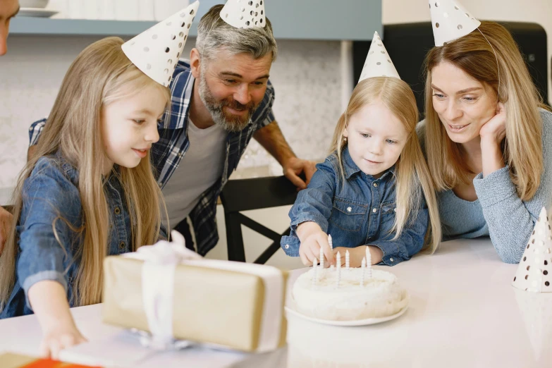 a family celebrating a birthday with a cake, pexels contest winner, wearing a grey wizard hat, thumbnail, 1 petapixel image, foil