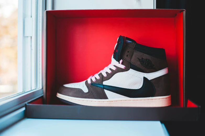 a pair of sneakers in a box on a window sill, inspired by Jordan Grimmer, unsplash, air jordan 1 high, brown, album art young thug, uniform off - white sky