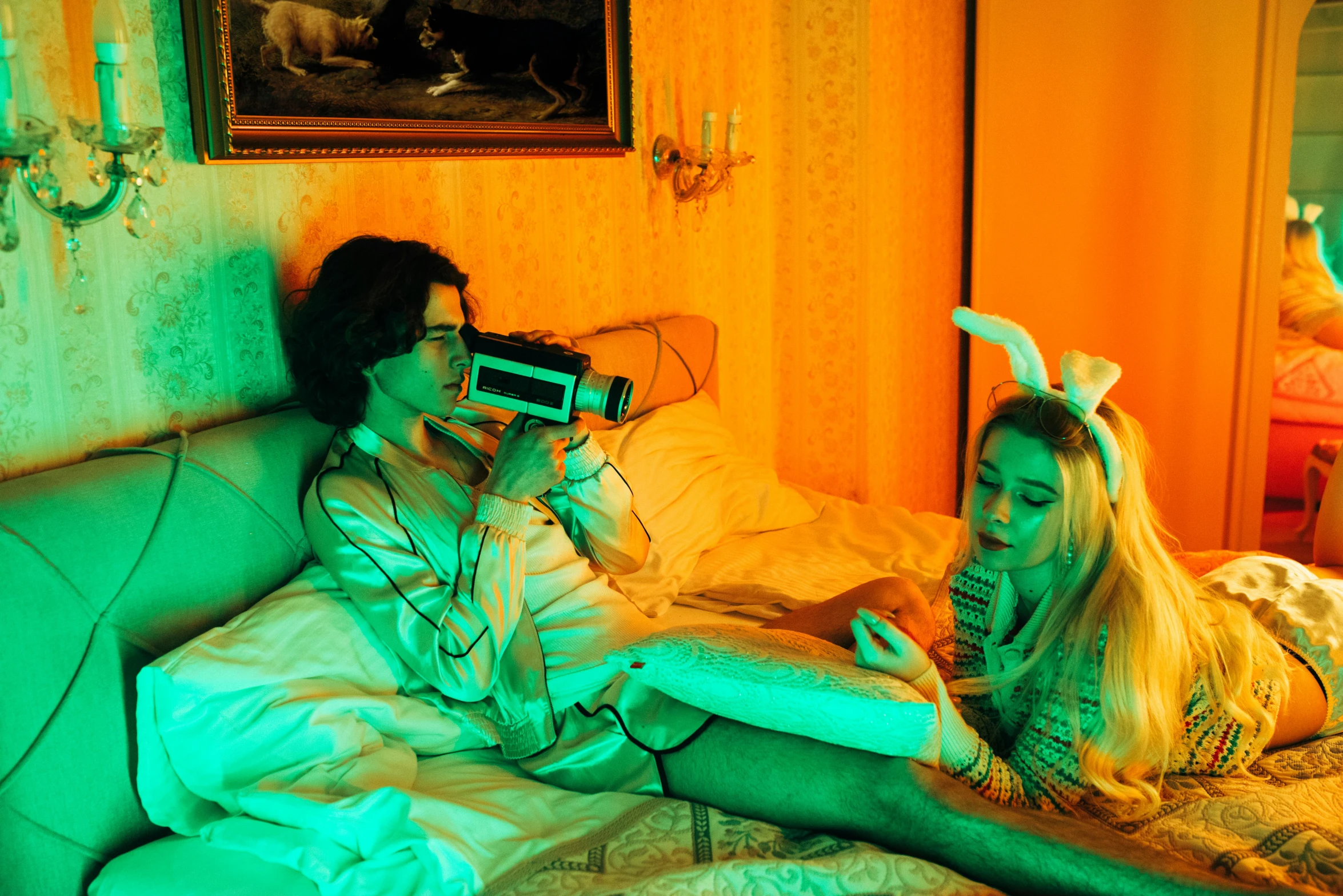 a couple of women laying on top of a bed, an album cover, inspired by Elsa Bleda, pexels contest winner, magic realism, dali lobster phone, neon operator margot robbie, elves sitting on the couch, timothee chalamet