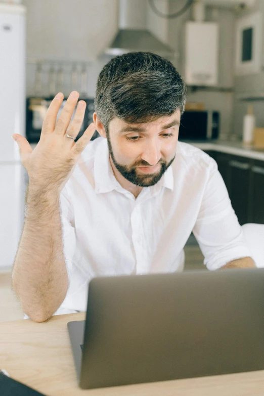 a man sitting at a table in front of a laptop, shrugging, scruffy man, reddit post, dynamic closeup