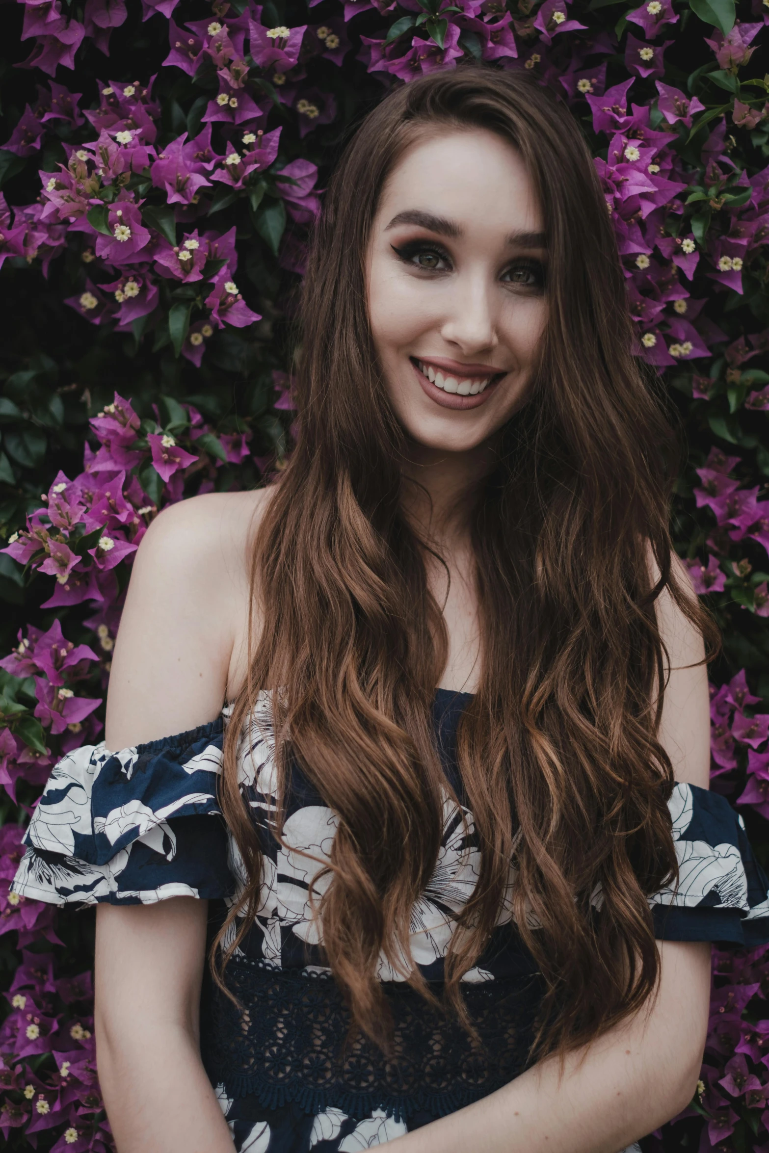 a woman standing in front of a bush of purple flowers, an album cover, inspired by Julia Pishtar, pexels contest winner, madison beer girl portrait, discord profile picture, happily smiling at the camera, lily collins