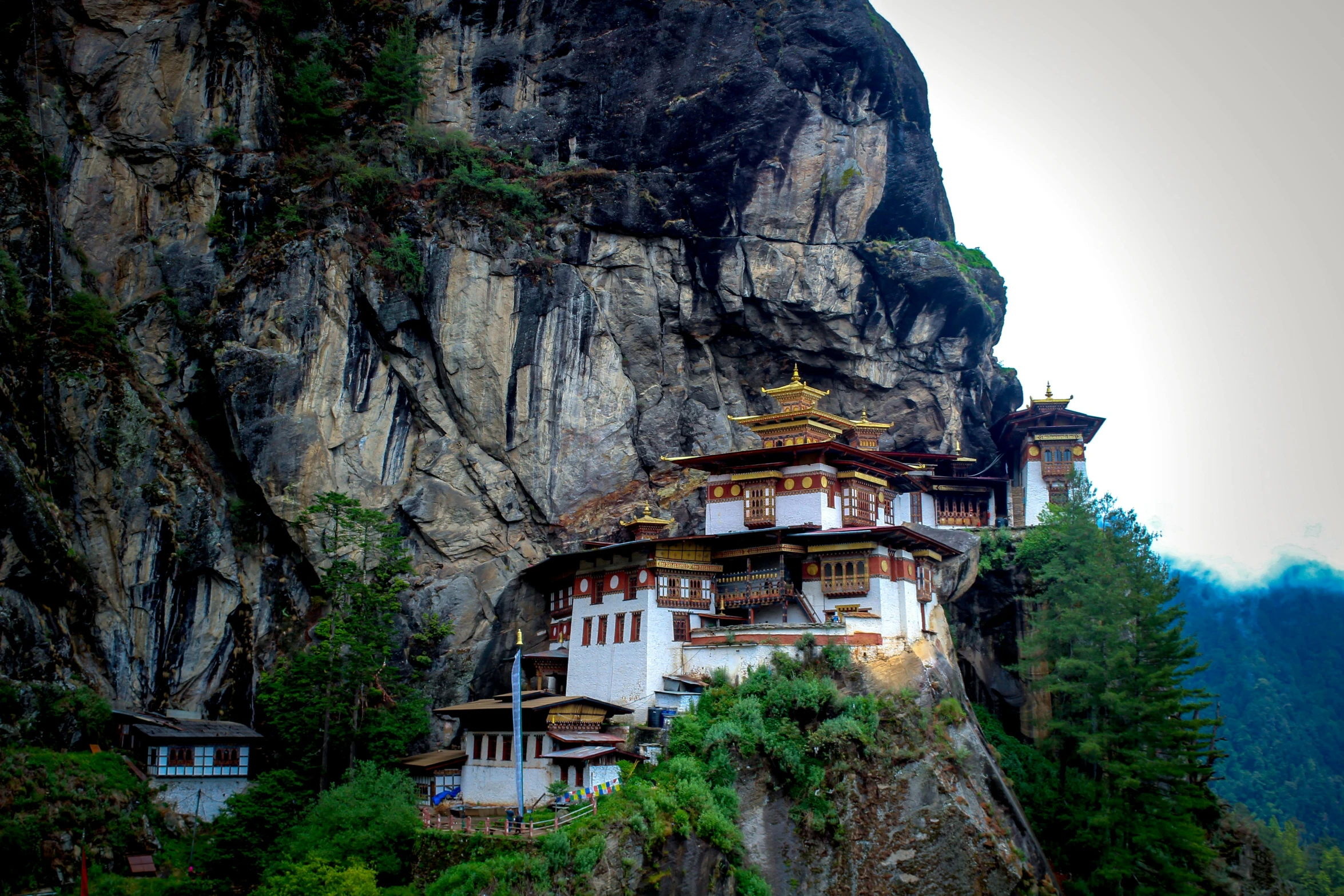a large white building sitting on top of a mountain, inspired by Steve McCurry, pexels contest winner, hurufiyya, bhutan, avatar image, festivals