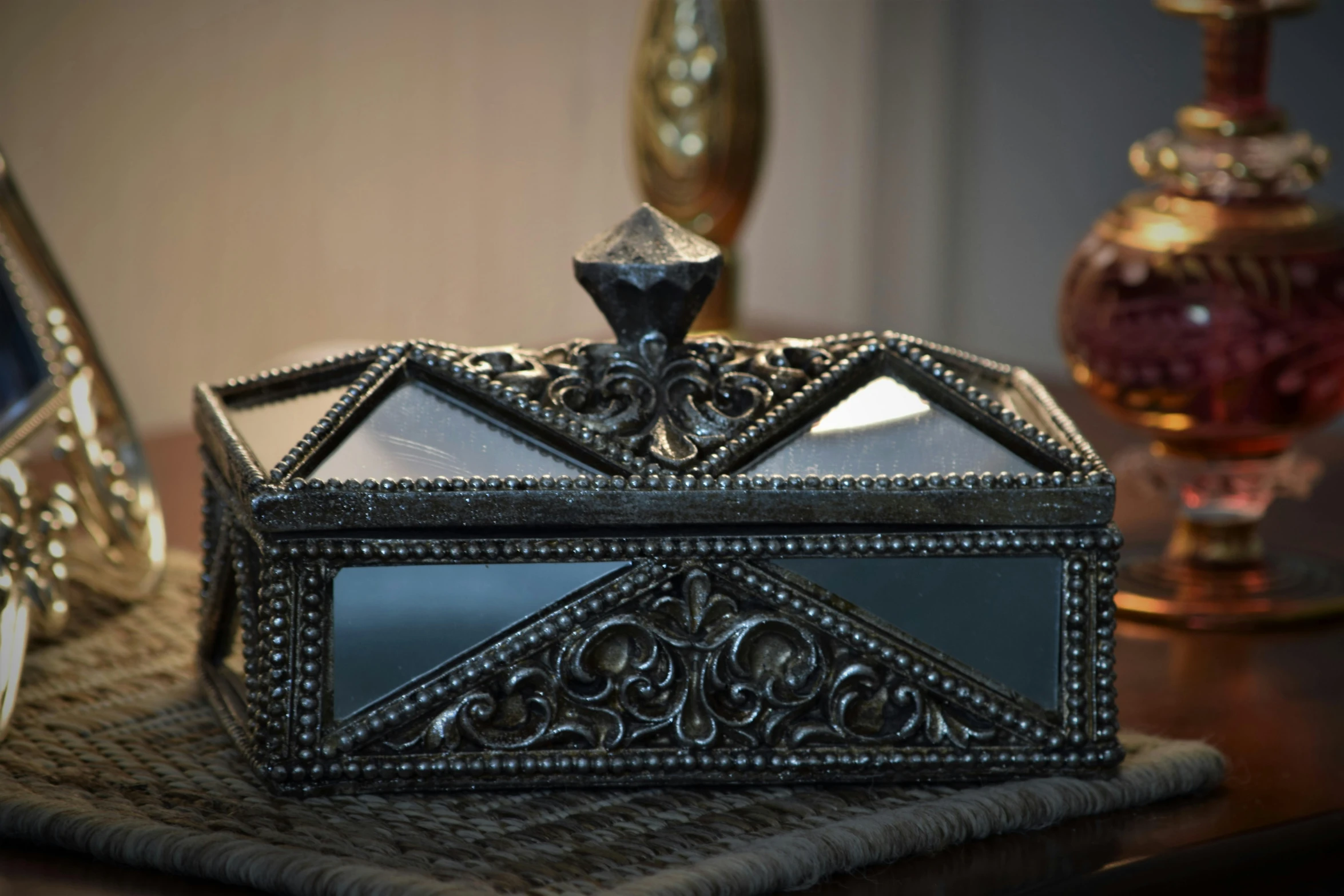 a silver box sitting on top of a table, gunmetal grey, gothic regal, morning light, glass