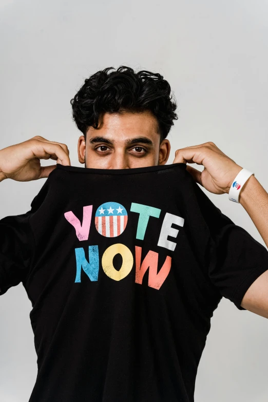 a man wearing a t - shirt that says vote now, an album cover, sayem reza, lgbtq, promo image, ap photo