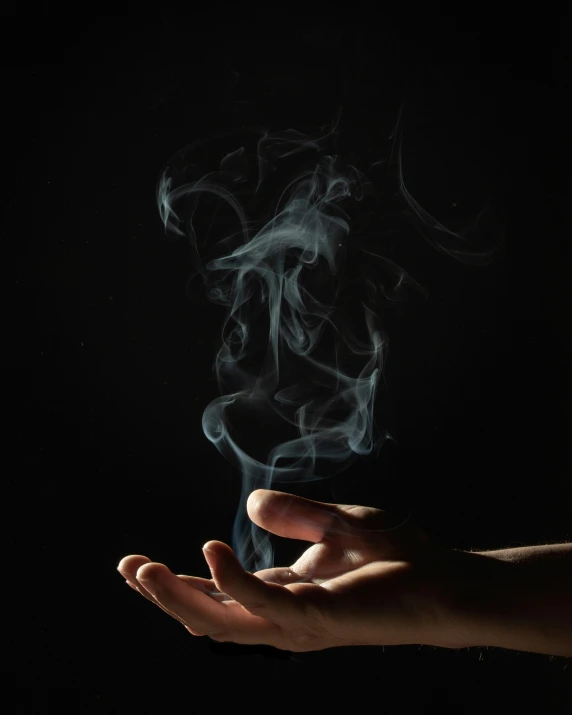 a person holding out their hand with smoke coming out of it, profile image