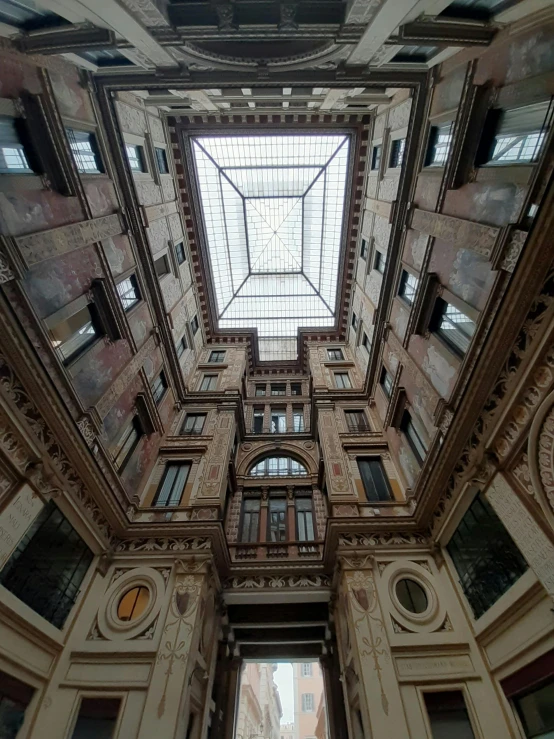 a very tall building with a skylight above it, inspired by Alessandro Allori, neoclassicism, indoor picture, lots of building, in the center of the image, color photo