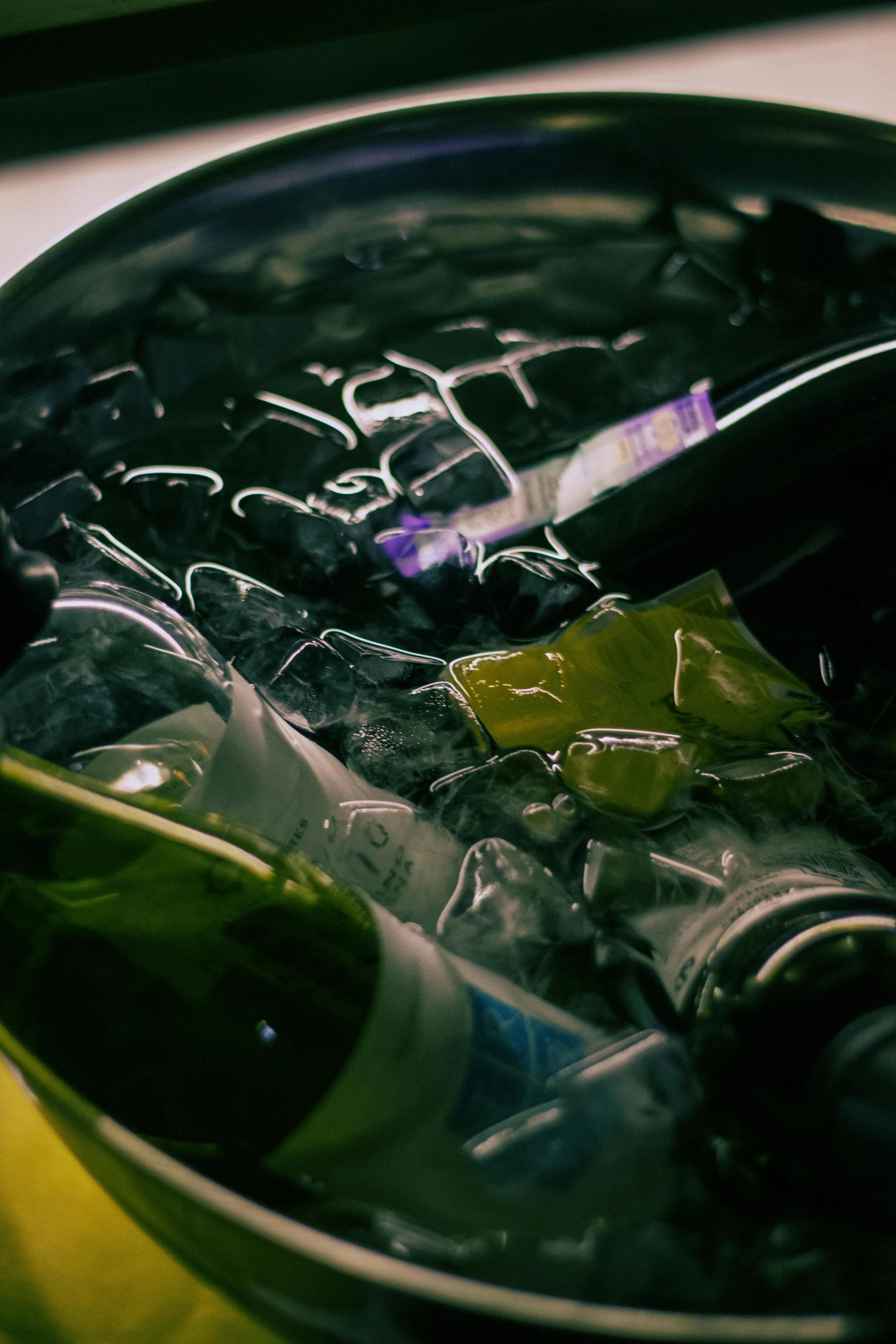 a close up of a bottle of wine in an ice bucket, by Adam Marczyński, scattered rubbish, chillhop, 15081959 21121991 01012000 4k