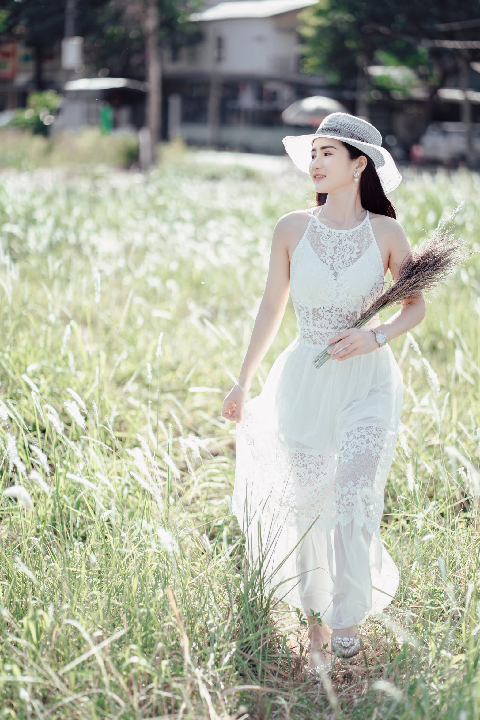 a woman walking through a field of tall grass, by Tan Ting-pho, pexels contest winner, elegant white dress, white hat, gorgeous chinese model, lace dress