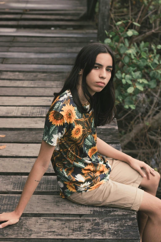 a woman sitting on top of a wooden bridge, a picture, unsplash, renaissance, sunflowers in the background, black teenage boy, summer shirt, official store photo