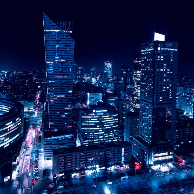 an aerial view of a city at night, by Adam Marczyński, warsaw, high blue lights, square, high quality photo