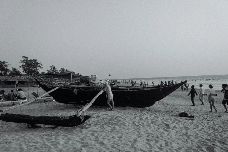 a group of people standing on top of a sandy beach, a black and white photo, pexels contest winner, fishing boats, :: morning, desktop wallpaper, making of