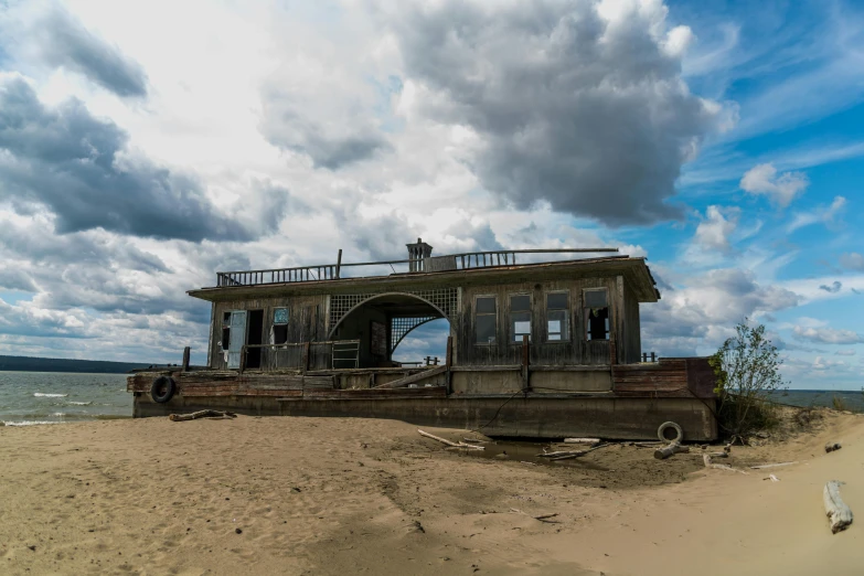 a boat sitting on top of a sandy beach, by Adam Marczyński, pexels contest winner, renaissance, derelict house, panorama, front side view, slide show