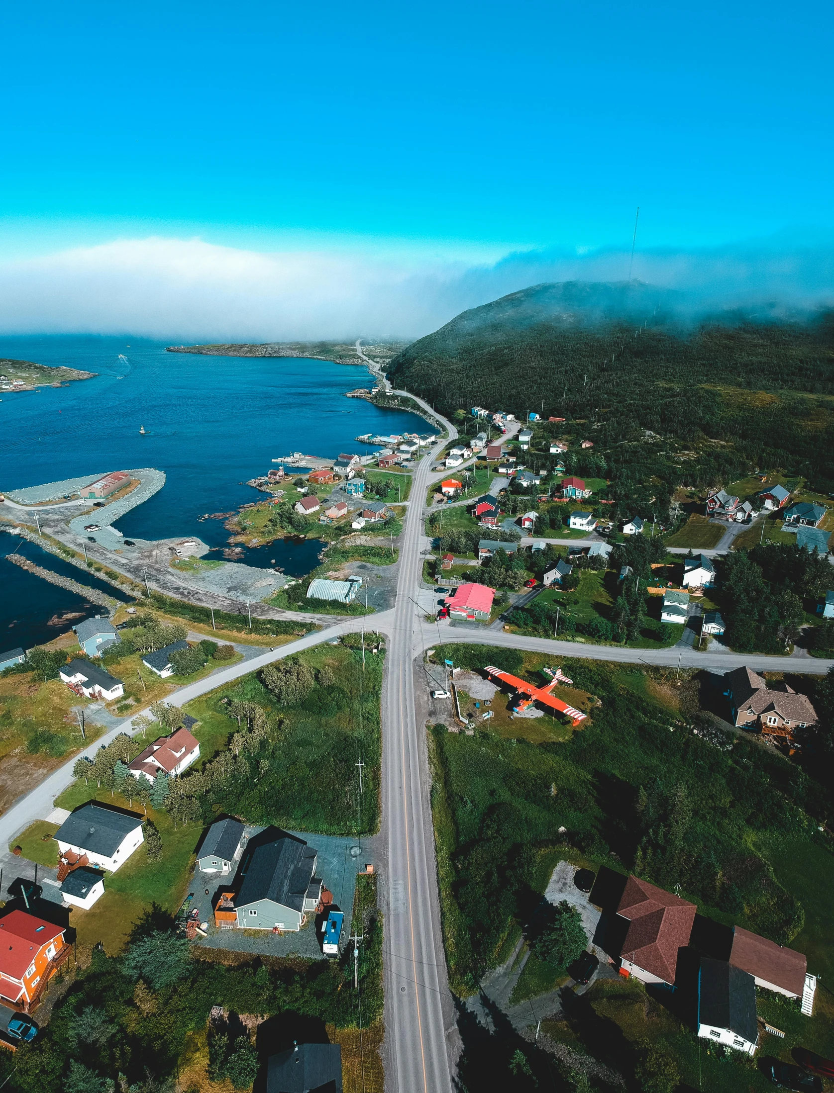 an aerial view of a town next to a body of water, road to the sea, thumbnail, yolie leif, gopro photo