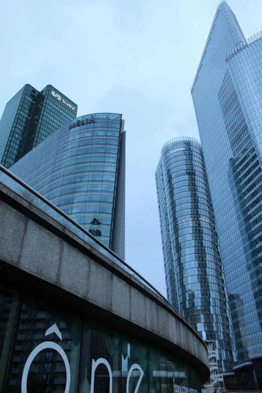 a group of tall buildings sitting next to each other, inspired by Zaha Hadid, reddit, warsaw, sky bridge, high quality photo, low angle!!!!