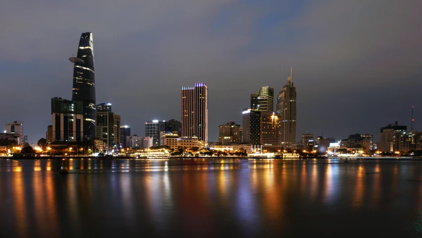 a large body of water with a city in the background, pexels contest winner, hurufiyya, vietnam, neon megacity in the background, foster and partners, highly detailded'