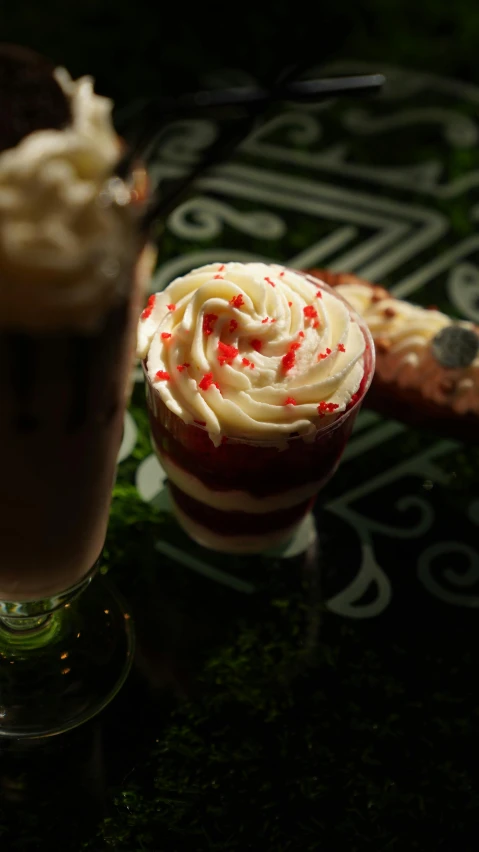 a couple of desserts sitting on top of a table, red stripe, thumbnail, tall shot, close-up photo