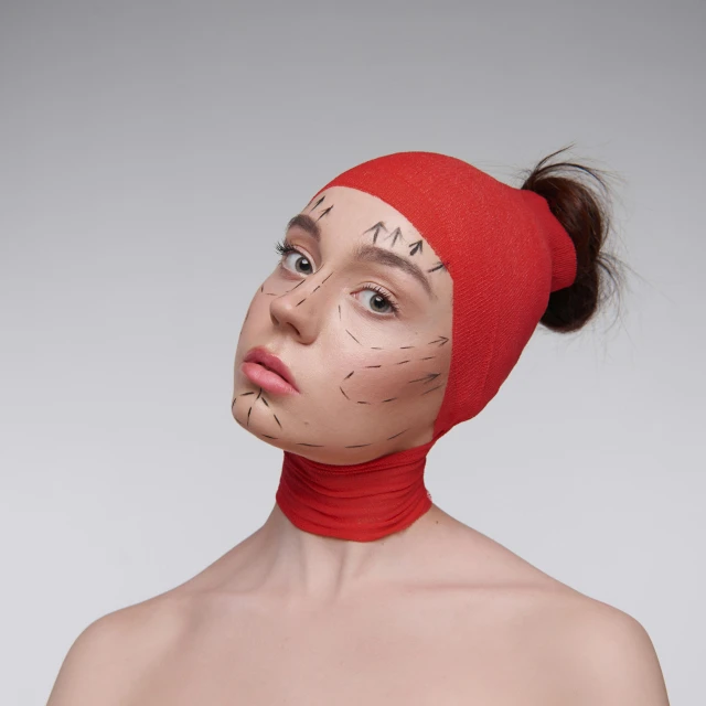 a woman with plastic surgery on her face, an album cover, inspired by Marina Abramović, trending on pexels, hyperrealism, red cap, bandage, thin face structure, realistic cosplay