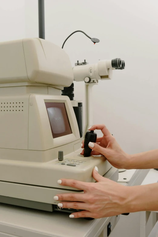 a close up of a person using a machine, a very macular woman in white, early 2 0 0 0 s, digital image, luxury equipment