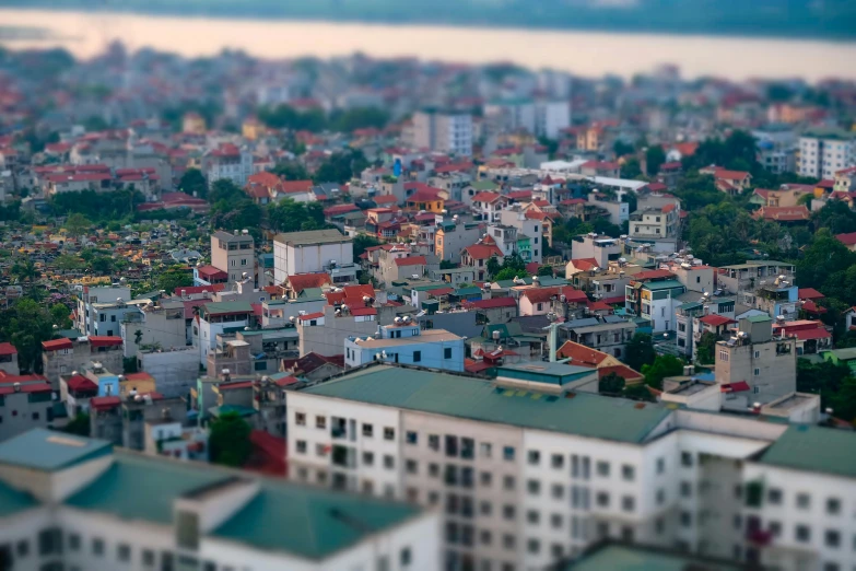 a view of a city from the top of a building, a tilt shift photo, unsplash, vietnam, 2 0 2 2 photo, white buildings with red roofs, unfocused