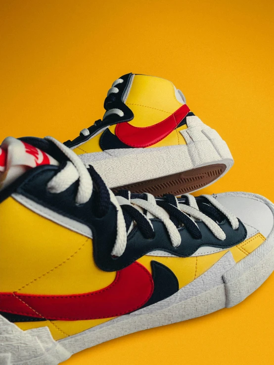 a pair of sneakers on a yellow background, inspired by Okuda Gensō, trending on unsplash, photorealism, wearing red and yellow hero suit, vintage disney, zoomed in shots, close up high detailed