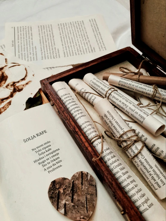 an open book sitting on top of a table, detailed string text, flatlay book collection, discarded scrolls, instagram story