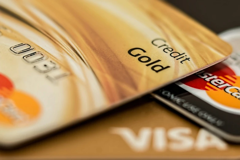 credit cards stacked on top of each other, by Adam Marczyński, pexels contest winner, visual art, brown and gold, australia, promo image, liquid gold