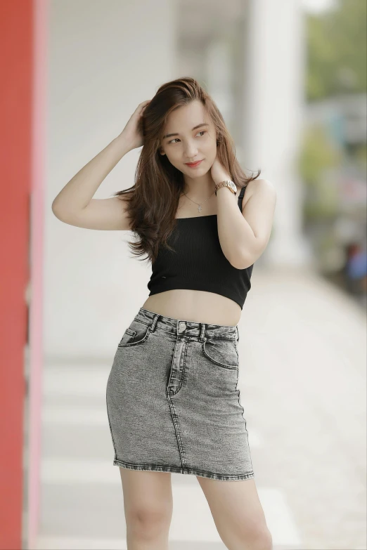 a woman in a skirt posing for a picture, by Reuben Tam, trending on pexels, realism, wearing a cropped black tank top, dang my linh, very beautiful young woman, square