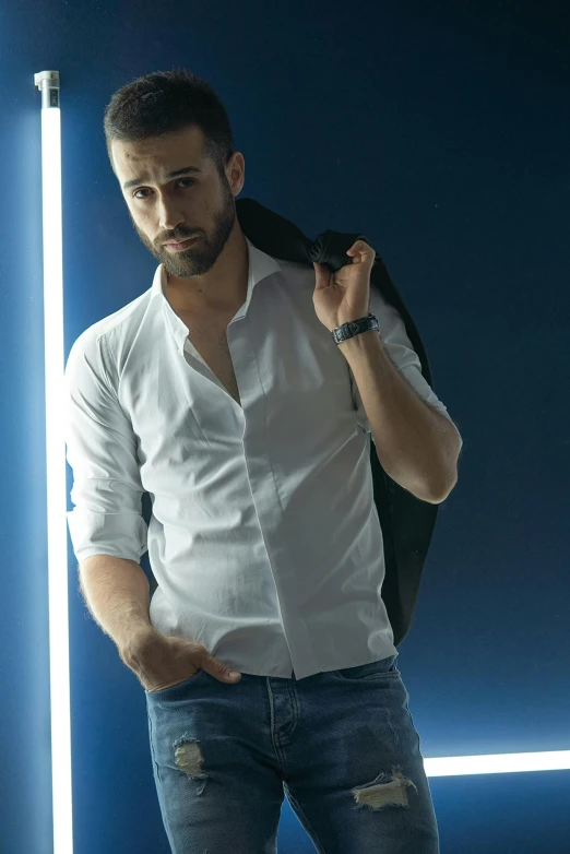 a man standing in front of a neon light, inspired by Germán Londoño, white shirt and jeans, professional modeling, square, daniel ricciardo