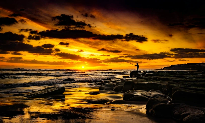 a man fishing at sunset on the beach, by Peter Churcher, pexels contest winner, gold coast australia, deep colours. ”, yellow, marsden