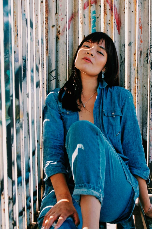 a beautiful young woman sitting on top of a skateboard, an album cover, trending on unsplash, photorealism, mary elizabeth winstead, wearing double denim, center parted curtain bangs, ana de la reguera portrait