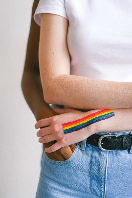 a woman with a rainbow painted on her arm, by Nina Hamnett, trending on pexels, renaissance, two male, varying ethnicities, meredith schomburg, 256435456k film