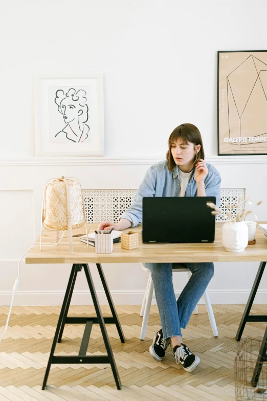 a woman sitting at a desk using a laptop computer, trending on pexels, arbeitsrat für kunst, girl making a phone call, sitting in an empty white room, featured art, dwell