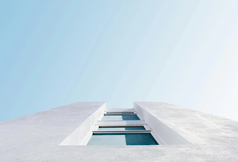 a tall white building with a blue sky in the background, a minimalist painting, pexels contest winner, minimalism, looking out, passive house, greek architecture, aquamarine windows