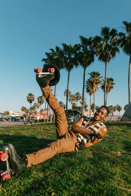 a man laying in the grass with a skateboard, pexels contest winner, happening, with palm trees in the back, in a jumping float pose, ashteroth, hollywood standard