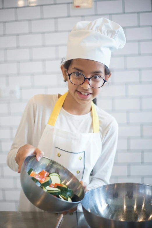 a woman in a chef's hat holding a bowl of food, girl wearing round glasses, ameera al-taweel, asian male, profile image