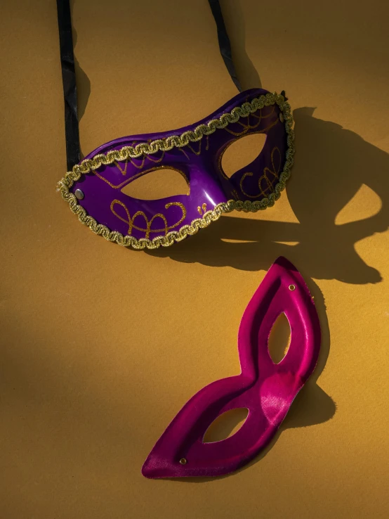 a couple of masks sitting on top of a table, by Matt Cavotta, trending on pexels, ((purple)), soft shadow, carneval, eye patch