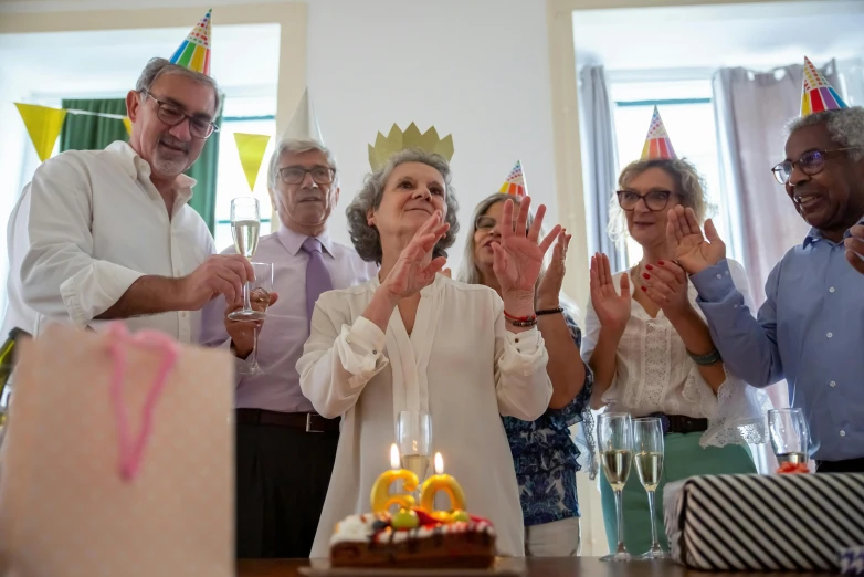 a group of people standing around a birthday cake, a portrait, pexels contest winner, figuration libre, old lady, party hats, promo image