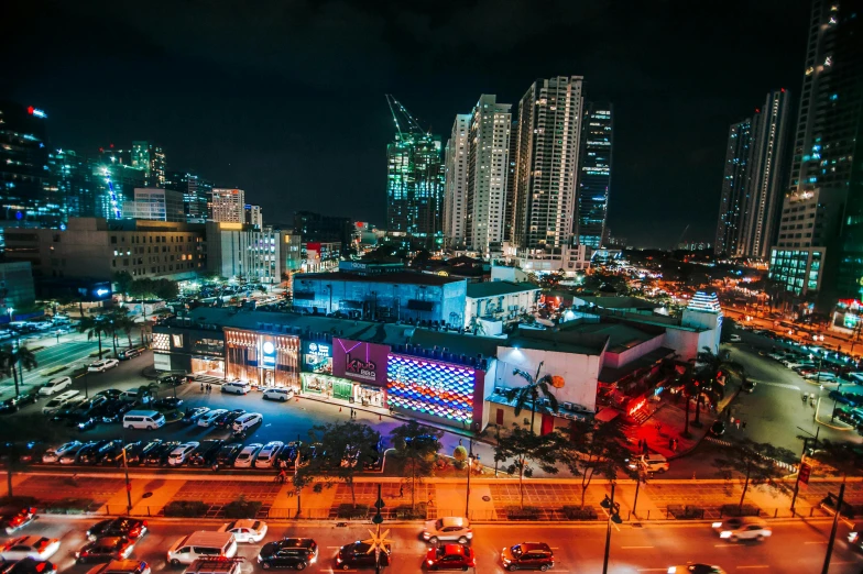 an aerial view of a city at night, by Robbie Trevino, pexels contest winner, maximalism, palms and miami buildings, chinatown, projection mapping, philippines