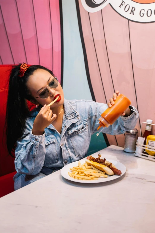 a woman sitting at a table in front of a plate of food, pexels contest winner, pop art, hot dog, charli xcx, spilling juice, style of chippy