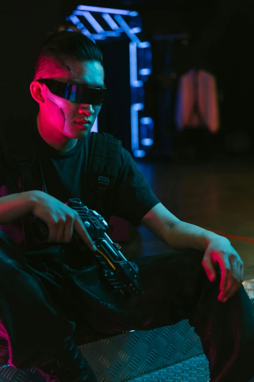 a man that is sitting down with a gun, cyberpunk art, inspired by Zhu Da, pexels, realism, wearing 3 d glasses, scene from a rave, cinematography photo, concert