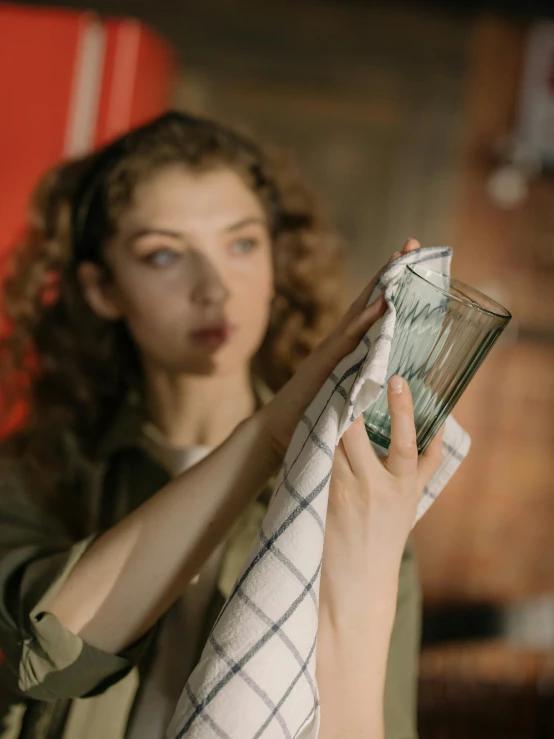 a woman holding a glass with money in it, a portrait, pexels, inspect in inventory image, striped, maintenance, square